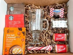 the starbucks hot cocoa gift box is packed with coffee, marshmallows, and cookies