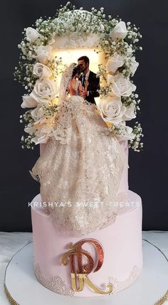 a wedding cake with a bride and groom on top