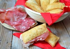 some food that is sitting in a bowl on a table with red napkins around it