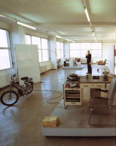 an empty room with chairs, desks and other items on the floor in it