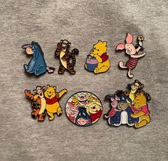 winnie the pooh and friends pin set on a grey t - shirt with other disney characters