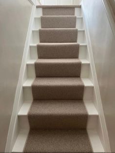 a carpeted staircase leading up to the second floor