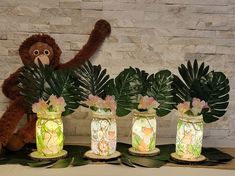 Close your eyes and take yourself and your guest to a trip to the jungle with breath taking and beautiful centerpieces. Displays are Glass Jars decorated with cute jungle animal pictures and sealed with Mod Podge giving it a vintage distress finish with warm led lights that make each character stand out and at the same time a elegant touch perfect for a baby shower, kids party or even a perfect decoration for a kids bed room. Size of Jars are 32 oz If ordering multiples please allow for extra shipping time as centerpieces are handcrafted as orders are received. Please Allow for some minor variations since all are individually handmade. If ordering multiples please allow extra time for shipping orders are started as soon as order is received.  If you have a different theme in mind please co Table Centerpieces Safari, Animal Baby Shower Centerpieces, Safari Kids Party, Jungle Animals Pictures, Girl Baby Shower Decor, Kids Bed Room, Tiffany Baby Showers, Girl Baby Shower Centerpieces, Kids Party Decor