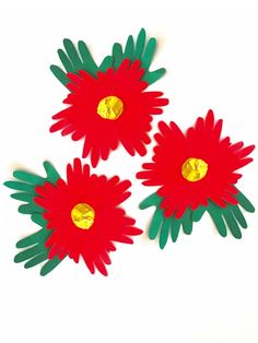 three red flowers with green stems and gold centers on white background, cut out from paper