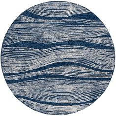 a blue and white rug with wavy lines on the bottom, in an oval shape