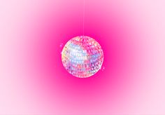 a disco ball hanging from a string on a pink background