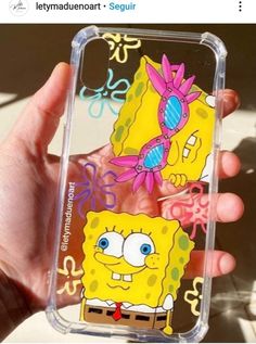 someone is holding up their phone case with spongebob on it