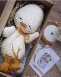 a crocheted stuffed animal in a box