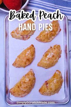 baked peach hand pies on a baking sheet with apples in the background and text overlay