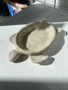 a small ceramic turtle sitting on top of a table