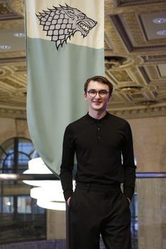 a man standing in front of a flag