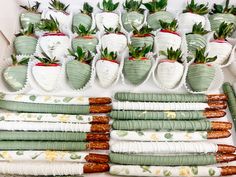 there are many strawberries and other desserts on the table with green napkins