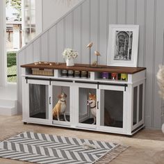 two dogs sitting in their kennels on the floor next to a stair case