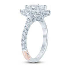 a diamond engagement ring with three stones on the band and an oval center stone in the middle