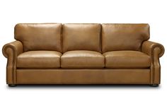 a brown leather couch sitting on top of a white floor