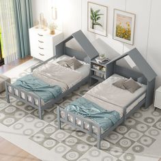 two twin beds in a room with white walls and wooden flooring, one has a bookcase on the other side