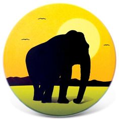 an elephant is silhouetted against the setting sun in this round magnet that has been designed to look like it's standing on land