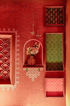 the wall is painted red, green and pink with intricate designs on it's sides