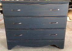 an old dresser is painted blue and has silver handles