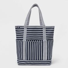 This canvas beach tote is just what you need to keep everything together. The fabric is durable yet lightweight, making it perfect as a beach bag, to carry your laptop – whatever you require. Pockets keep your smaller items easy to find and secure. Neatly-stitched seams give it a clean look - now you just need to choose which matches best with your favorite suit! White Canvas Diaper Bag For Travel, Blue Beach Weekend Bag, Navy Beach Bag For Daily Summer Use, Navy Beach Bag For Daily Use In Summer, Navy Rectangular Beach Bag For Travel, Navy Summer Tote Beach Bag, Navy Tote Beach Bag For Travel, Navy Tote Beach Bag, White Canvas Bag For Beach Season And Everyday Use