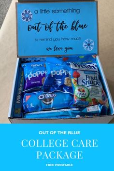 an open blue box filled with snacks and the text out of the blue college care package