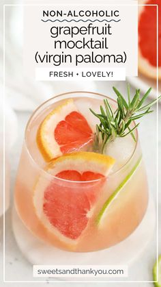 grapefruit cocktail in a glass garnished with orange slices and rosemary