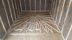 an unfinished room with wood framing in the floor