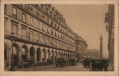 an old black and white photo of cars on a city street