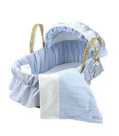 a blue and white baby bassinet with ruffles on the bottom, in front of a white background