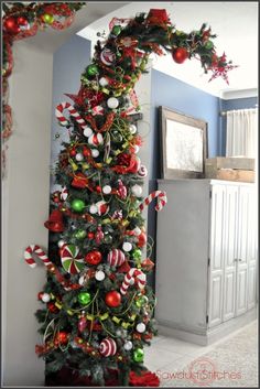 the christmas tree is decorated with red, green and white ornaments on it's branches