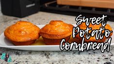 three muffins on a white plate with the words sweet potato cornbread above them