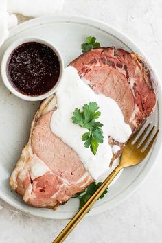 a white plate topped with meat and sauce