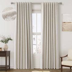 a living room with white curtains and a wooden chair in front of the window that is open