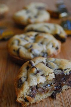 two chocolate chip cookies sitting on top of a wooden table