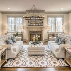 a living room filled with furniture and a fire place in the middle of a room