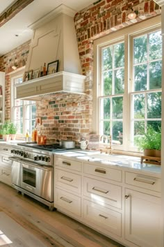 a kitchen with brick walls and white cabinets