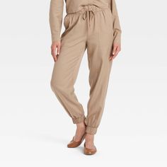 These High-Rise Jogger Pants from Universal Thread™ are made from lightweight lyocell fabric and tailored with a relaxed leg style to keep you in absolute comfort. The full elastic waist with drawstring offers an adjustable, secure fit, while the side pockets provide space for stashing everyday essentials. In a solid hue, they are easy to coordinate with a variety of tops for versatile wear. Universal Thread™: Found exclusively at Target. Lyocell Fabric, Slouchy Pants, Pants Large, Bottom Clothes, Universal Thread, Pull On Pants, Everyday Essentials, Womens Sweatpants, Jogger Pants