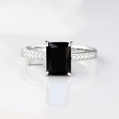 Gorgeous Natural Black Spinel Ring ►Made of solid sterling silver with rhodium finish(925) ►Accented With Simulated Diamonds (CZ) ►Wedding band is sold separately. Center Stone: Spinel Color: Black Stone cut: Emerald Gem size: 8.0x 6.0 mm Average Carat Weight: 1.5 ct. Stone Creation: 100% Natural Hardness: 8 (Mohs scale) ✓ 100% Nickel-Free ✓ Hypoallergenic ✓ Comfort Fit ✓ Free Ring Box ✓ Free USA Shipping ✓ Ready to ship next business day Classic Black Rings For Anniversary, Classic Black Diamond Ring As A Gift, Classic Black Diamond Ring Gift, Classic Black Diamond Ring For Gift, Classic Black Wedding Ring With Prong Setting, Classic Black Rings With Accent Stones, Classic Black Jewelry With Center Stone, Black Solitaire Wedding Ring, Classic Black Jewelry With Accent Stones