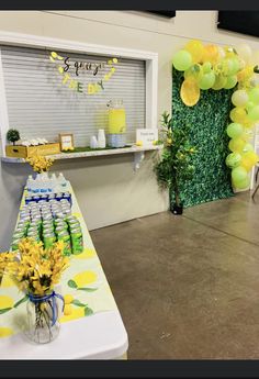 a table with yellow and green balloons on it