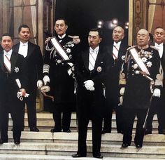 a group of men in suits and ties standing on steps