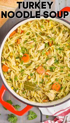 a pot filled with pasta and vegetables on top of a table