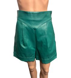 "This gorgeous pair of hip and trendy teal vegan leather shorts are the perfect next addition to your wardrobe! These shorts are made of vegan leather and are super trendy with an  80s inspired style. They're also in perfect vintage condition! These shorts are totally 80s and are great for an 80s themed costume or for everyday wear! Get these incredible shorts for yourself or for someone in your life who loves 80's inspired  fashion! Size 6 28\" Waist 18.5\" Long 3.5\" Inseam My photos are shots of the original item. Light or dark spots are reflections caused by the lighting. Color deviations can occur depending on the screen being used. Age of items are estimated based on my research and experience. Age differences may occur. US SHIPPING FREE  International shipping please see the rate  P Green Leather Shorts, 80s Themed Costumes, High-waisted Faux Leather Shorts For Summer, Luxury Leather High-waisted Shorts, Leather High-waisted Shorts With Belt Loops, 80s Inspired Fashion, High-waisted Faux Leather Shorts With Built-in Shorts, Short Cuir, Teal Outfits