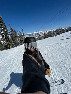 a person riding skis down a snow covered slope