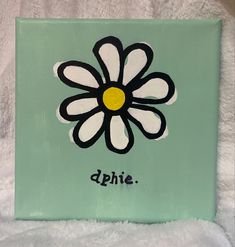 a painted flower on a green background with the word dahie written below it