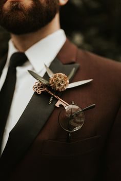 a man wearing a suit and tie with a boutonniere on his lapel