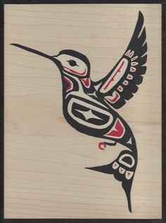 a bird painted on wood with black and red accents