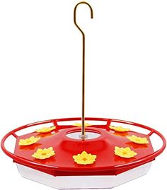 a red bird feeder with yellow flowers on it