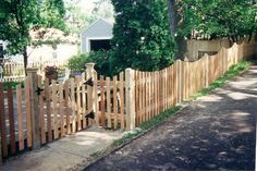 a wooden fence in front of a house