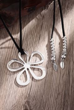 This Silvery Hollow Out Floral Leather Rope Y-shaped Necklace is the perfect combination of sophistication and beauty. The intricate floral design and delicate leather rope create a stunning Y-shaped necklace that adds a touch of elegance to any outfit. With its silver finish and unique silhouette, this necklace is sure to make a statement. Ballroom Shoes, Shoe Storage Bags, Leather Corded Necklace, Floral Pendant, Soft Floral, Floral Wraps, Rope Necklace, Cord Necklace, Beautiful Blooms