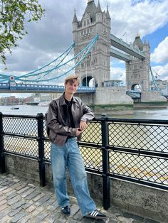 a man standing on the side of a bridge